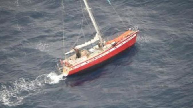 The relieved yachtie waving furiously to Orion crew from his stricken vessel. Photo / Supplied