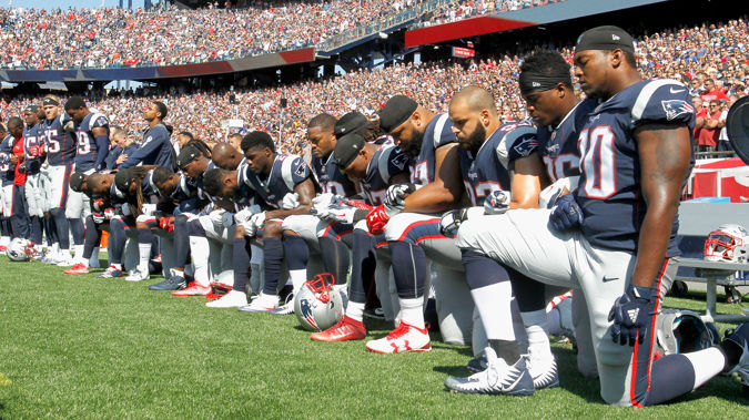 Members of the New England Patriots kneel during the National Anthem (Getty)