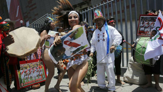 Shamans, witch doctors and dancers, perform a rite in an attempt to bring good luck to Peru's national soccer team. (Photo / AP)