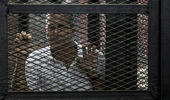 Rallies have been held in London and The Hague in support of three Al-Jazeera journalists marking a year in prison in Egypt (Getty Images)