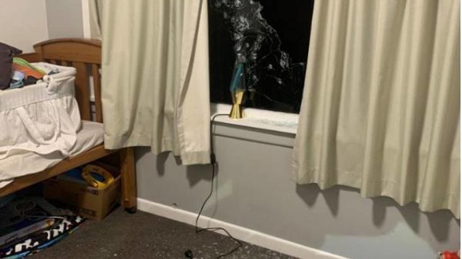 A child's bedroom strewn with shattered glass after being shot-out from outside in Wairoa on May 11. Photo / NZ Police
