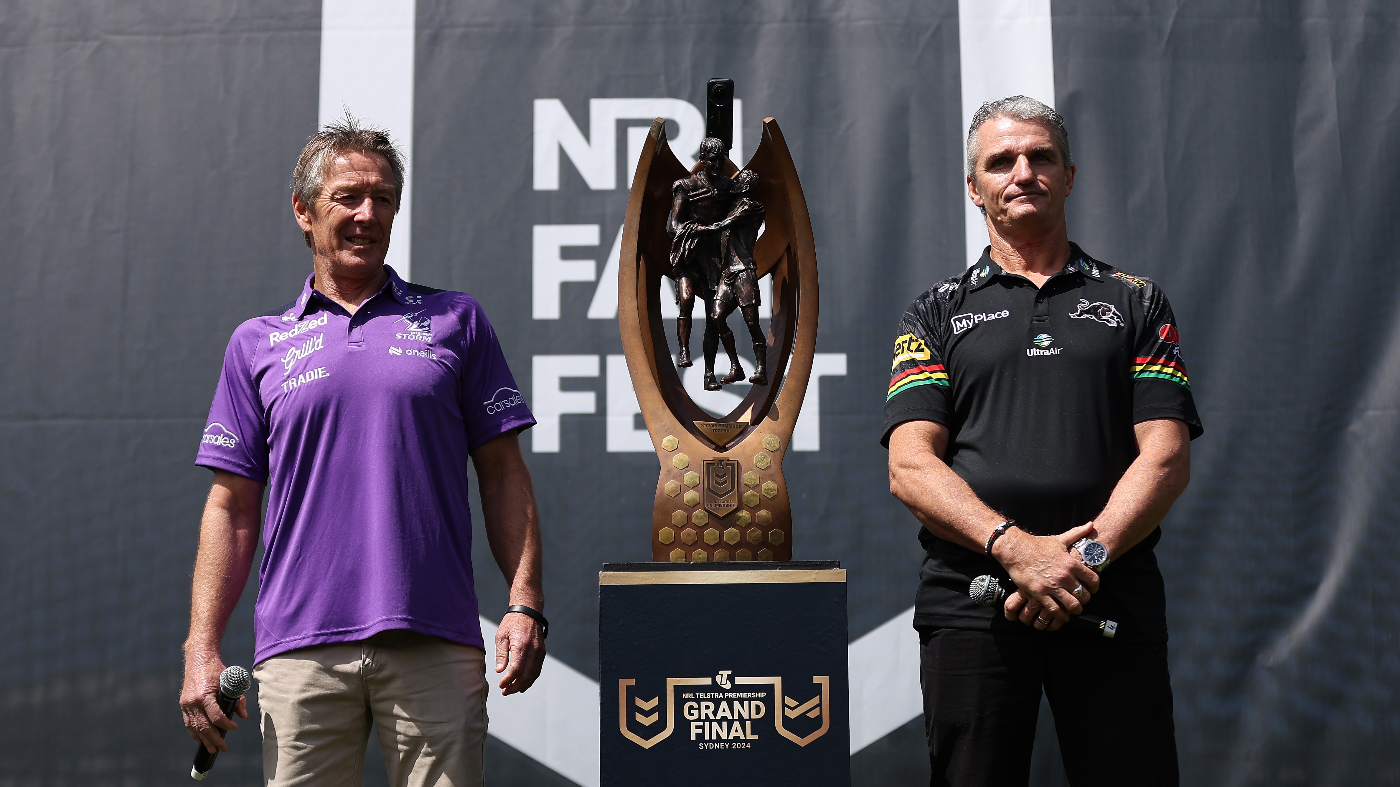 Craig Bellamy, coach of the Storm and Ivan Cleary, coach of the Panthers pose alongside the Provan-Summons Trophy during NRL Grand Final Fan Fest at Overseas Passenger Terminal, on October 03, 2024, in Sydney, Australia. (Photo by Brendon Thorne/Getty Images)
