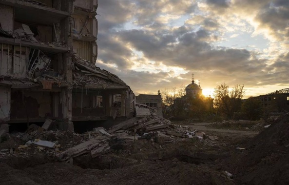 The sun sets over a destroyed building in Izyum, Ukraine. Photo / AP