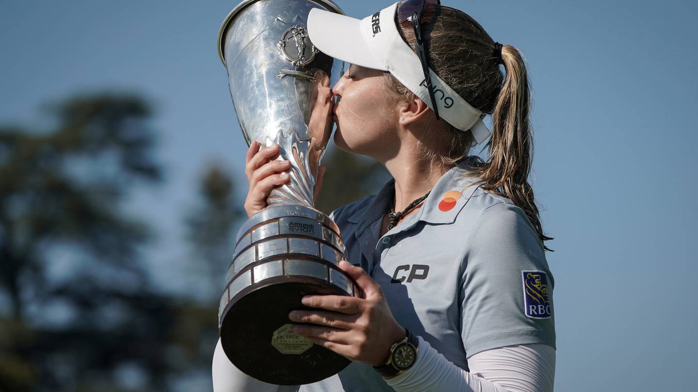 Brooke Henderson, of Canada, kisses her trophy after winning the Evian Championship. Photo / AP