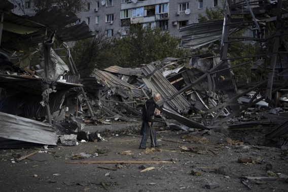 An elderly man walks past a car shop that was destroyed after a Russian attack in Zaporizhzhia, Ukraine. Photo / AP