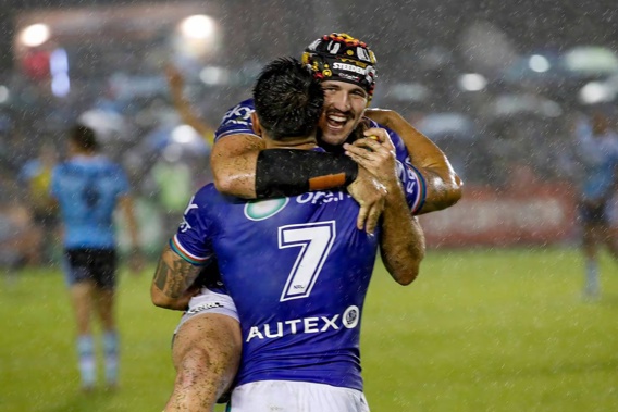 Former player Josh Curran and superstar Shaun Johnson celebrate after last years heroic comeback victory. Photo / Photosport