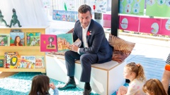 Associate Education Minister David Seymour reads to children at the Co Kids Thorndon Quay early childhood education centre. Photo / Mark Mitchell