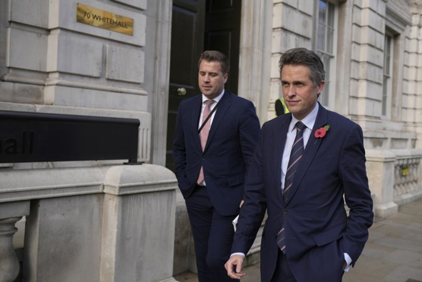 British lawmaker Gavin Williamson, right, Minister of State without Portfolio, leaves the Cabinet Office in London, Monday, Oct. 31, 2022. (AP Photo/Alastair Grant)
