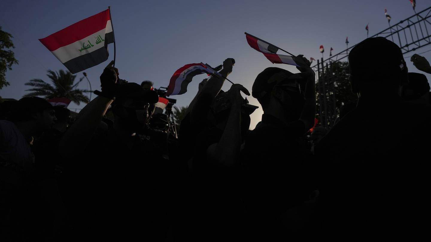 Protesters wave national flags during a protest outside the to the fortified Green Zone where the Danish embassy is located in Baghdad, Iraq on Saturday July 22 following reports of the burning of a Quran carried out by an ultranationalist group in front of the Iraqi Embassy in Copenhagen. Photo / AP