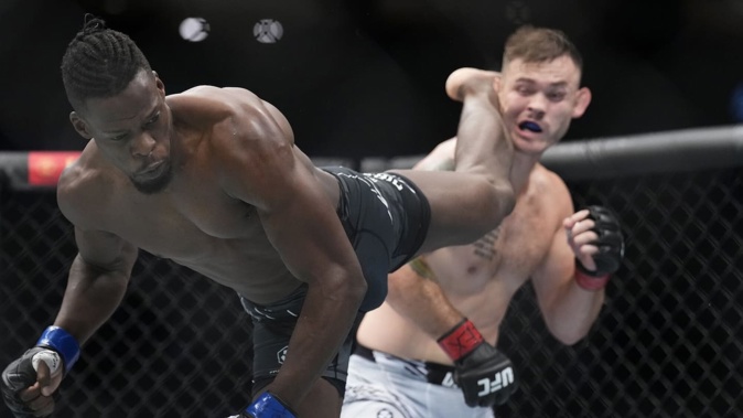 Blood Diamond lands a head kick in his UFC bout against Orion Cosce. Cosce won by unanimous decision. Photo / Getty Images