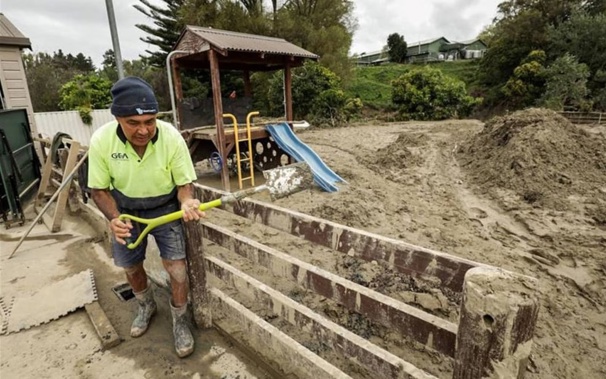 Locals helping clean up around houses in Gisborne after Cyclone Gabrielle. Photo: RNZ/Nathan McKinnon