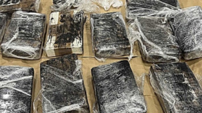 Five duffle bags stacked with bricks of cocaine valued at close to $30 million have been unpacked at a Mount Wellington business. Photo / NZ Police