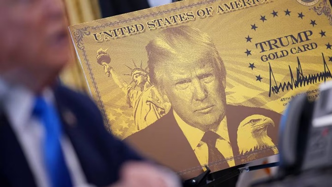 A poster of the “Trump Gold Card”, the visa allows foreign nationals permanent residency and a pathway to US citizenship for a US$1 million investment in the United States. Photo / Getty Images