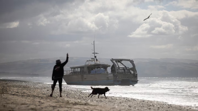 A fishing vessel has run aground at Waikuku Beach north of Christchurch, sparking an investigation. Photo / George Heard