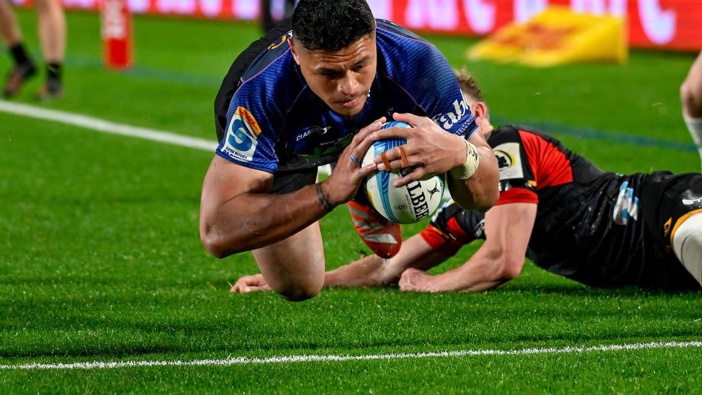 Caleb Clarke of the Blues dives for one of his three tries. Photo / Photosport