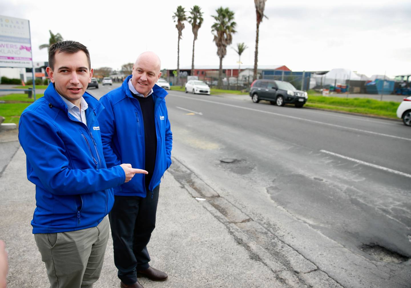 National transport spokesperson Simeon Brown and party leader Christopher Luxon point out a pothole. Photo / Alex Burton