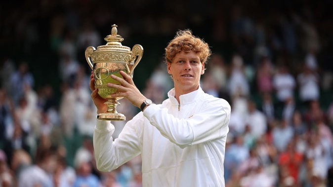 Italy's Jannik Sinner celebrates with the winner's trophy after beating Carlos Alcaraz in the 2025 Wimbledon men's final. Photo / AFP