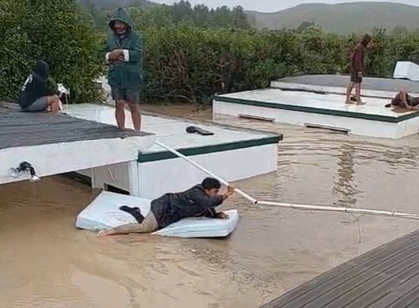 Workers at an orchard on the banks of the Tutaekuri River in Hawke's Bay have been forced onto roofs as flood waters leave them stranded. Photo / Lie Tu'imoala