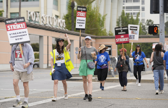 Picketers carry signs outside Fox studios on Monday, Aug. 14, 2023, in Los Angeles. The Hollywood writers strike passed the 100-day mark as the film and television industries remain paralyzed by dual actors and screenwriters strikes. Photo / AP