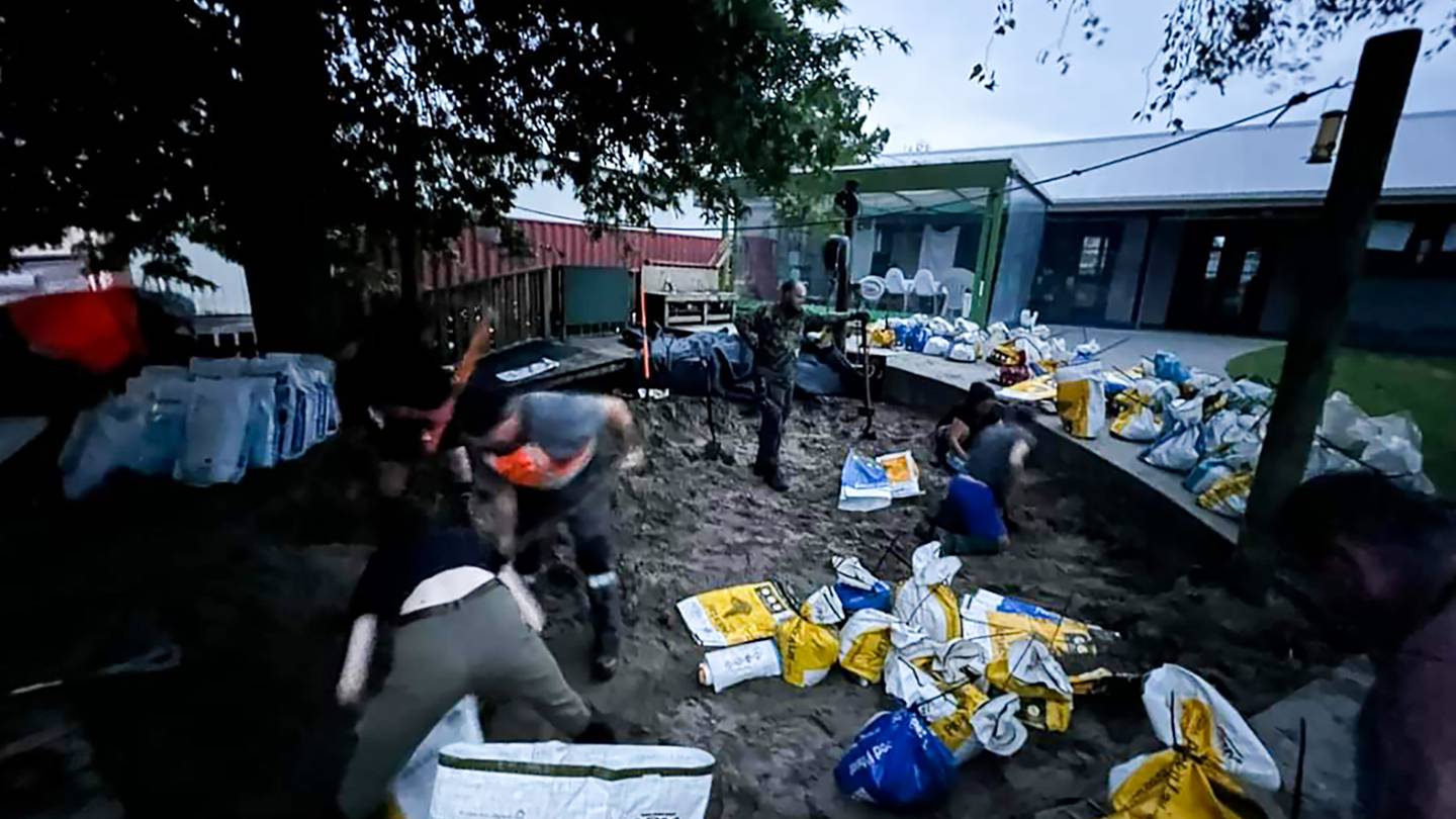 Volunteers make up sandbags from the sandpit at the Kumeu playcentre west Auckland in anticipation of flooding as heavy rain is predicted to hit the Auckland region. Photo / Supplied Morgan Julian 