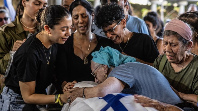 Family members mourn over the body of Israeli hostage Eden Yerushalmi during her funeral in Petah Tikva, Israel. She was one of the six captives found dead by Israeli forces last weekend. Photo / Heidi Levine for the Washington Post