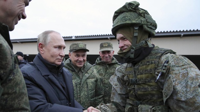 Russian President Vladimir Putin shakes hands with a soldier as he visits a military training centre of the Western Military District for mobilised reservists. Photo / AP