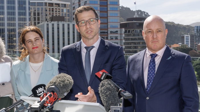 Prime Minister Christopher Luxon, Building & Construction Minister Chris Penk and Finance Minister Nicola Willis unveil significant changes to New Zealand’s earthquake-prone building system from the deck of MBIE’s building in Wellington. 29 September, 2025. Photo / Mark Mitchell