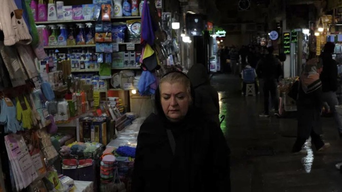 A woman walks through Tajrish bazaar in northern Tehran, Iran. Photo / AP