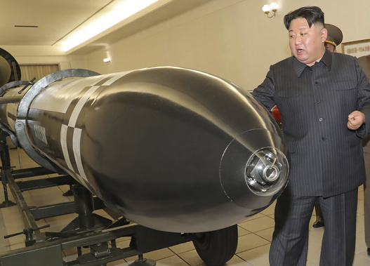 North Korean leader Kim Jong Un, rear, visits a hall displayed what appeared to be various types of warheads. Photo / AP