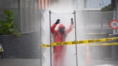 A Hazmat fire crew member being decontaminated in central Auckland. Photo / Jason Dorday