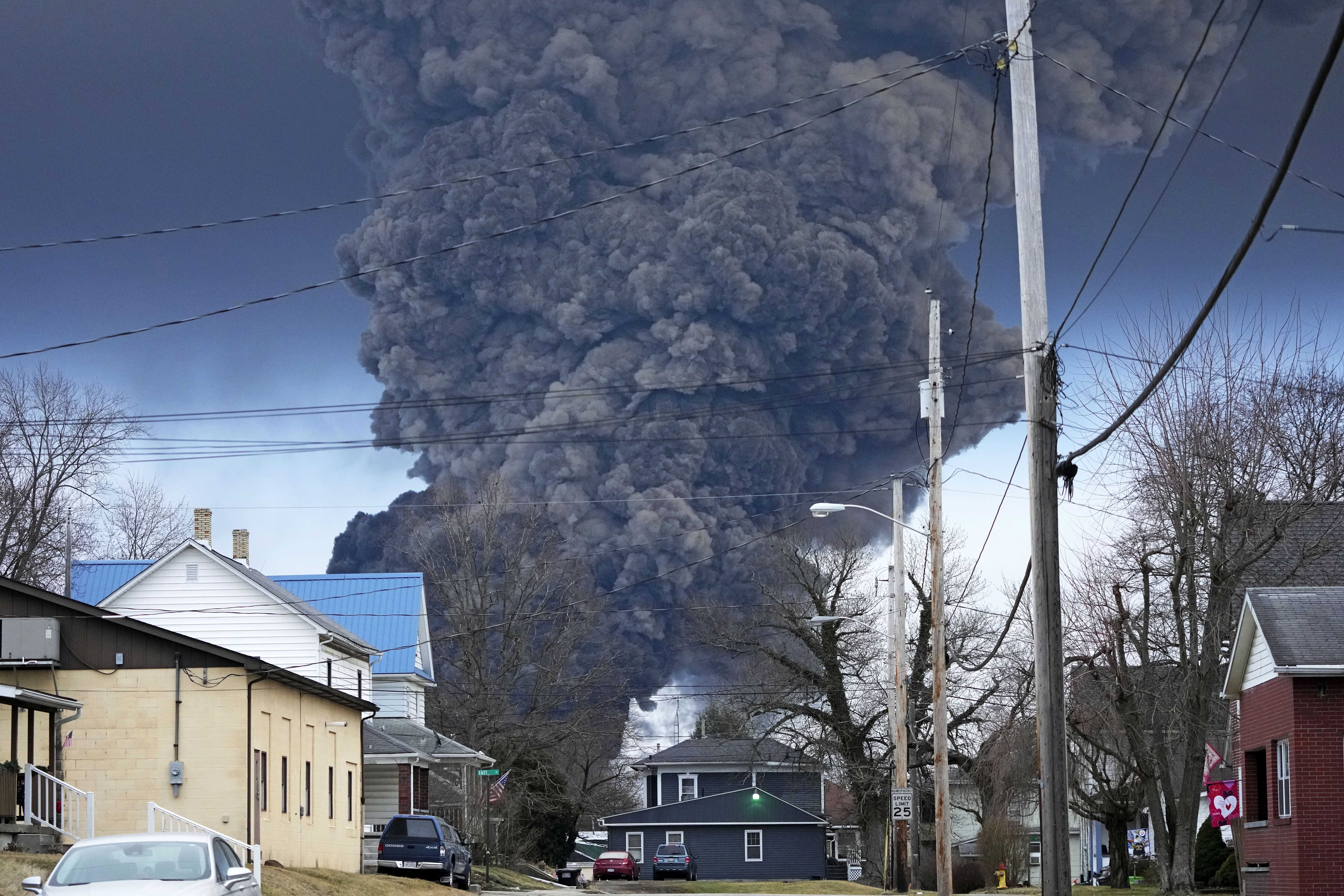 A black plume rises over East Palestine, Ohio, as a result of a controlled detonation of a portion of the derailed Norfolk Southern trains. Photo / AP