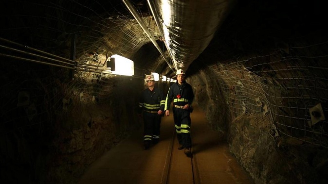 Two researchers walk through an old mining tunnel to what is now the Sanford Underground Research Facility. Photo / AP