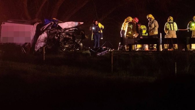 Police and FENZ investigating the crash on Main North Rd, north of Christchurch. Photo / George Heard