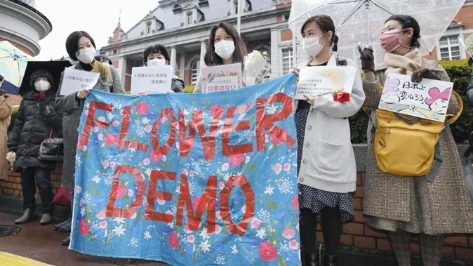 Japanese women hold a protest against sexual violence, in a movement dubbed the Flower Demo, on March 8, 2021, in Tokyo. Kyodo News/Getty Images