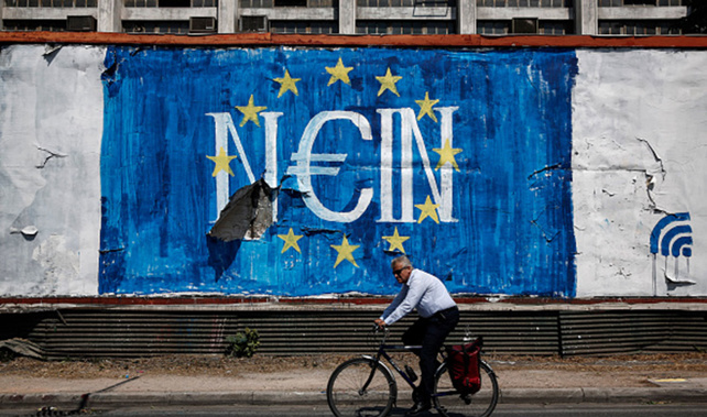 A cyclists passes graffiti street art on a billboard showing the stars of the European Union (EU) flag and the German word 'Nein', in Athens (Getty Images)