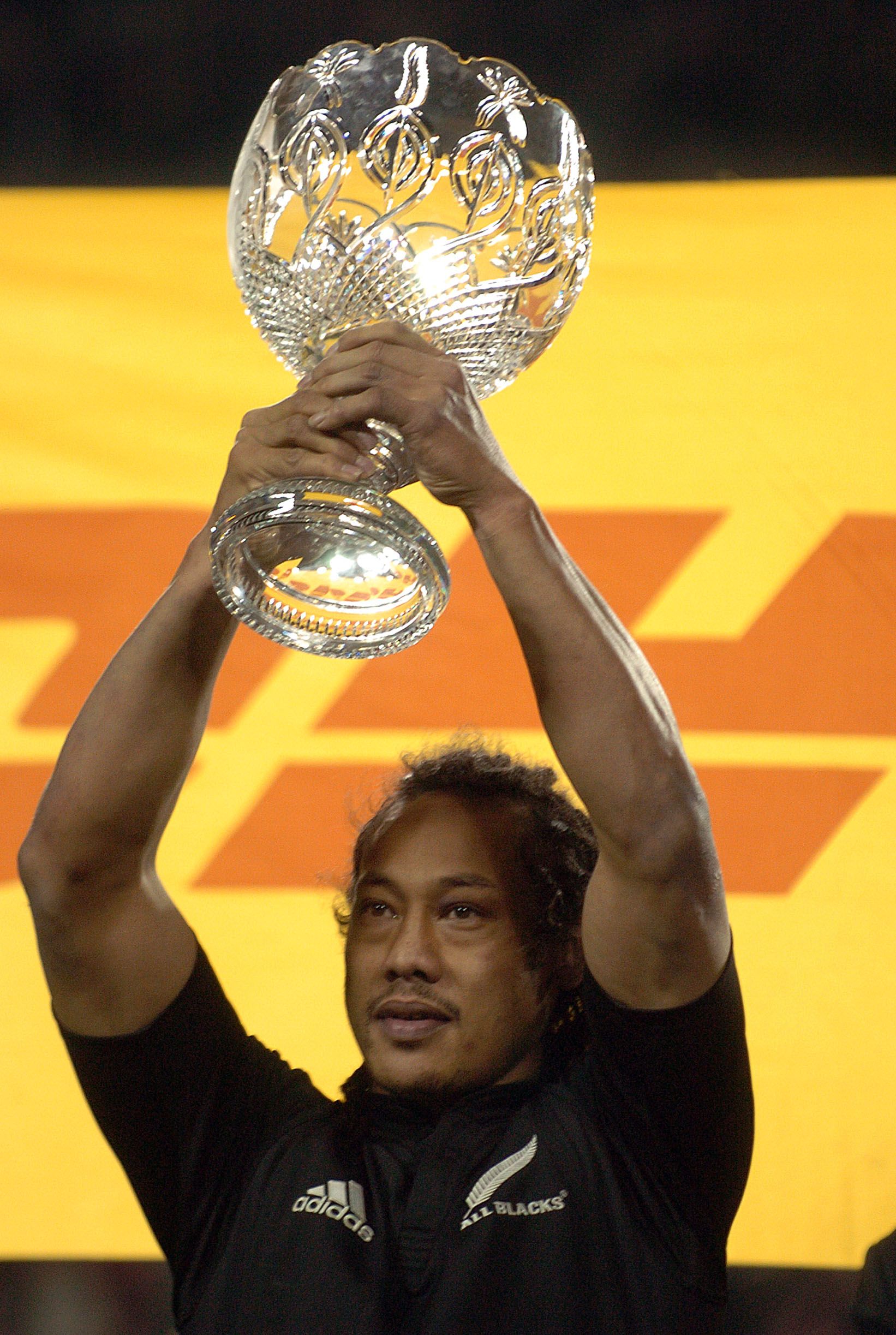All Blacks captain Tana Umaga holds the DHL series trophy.