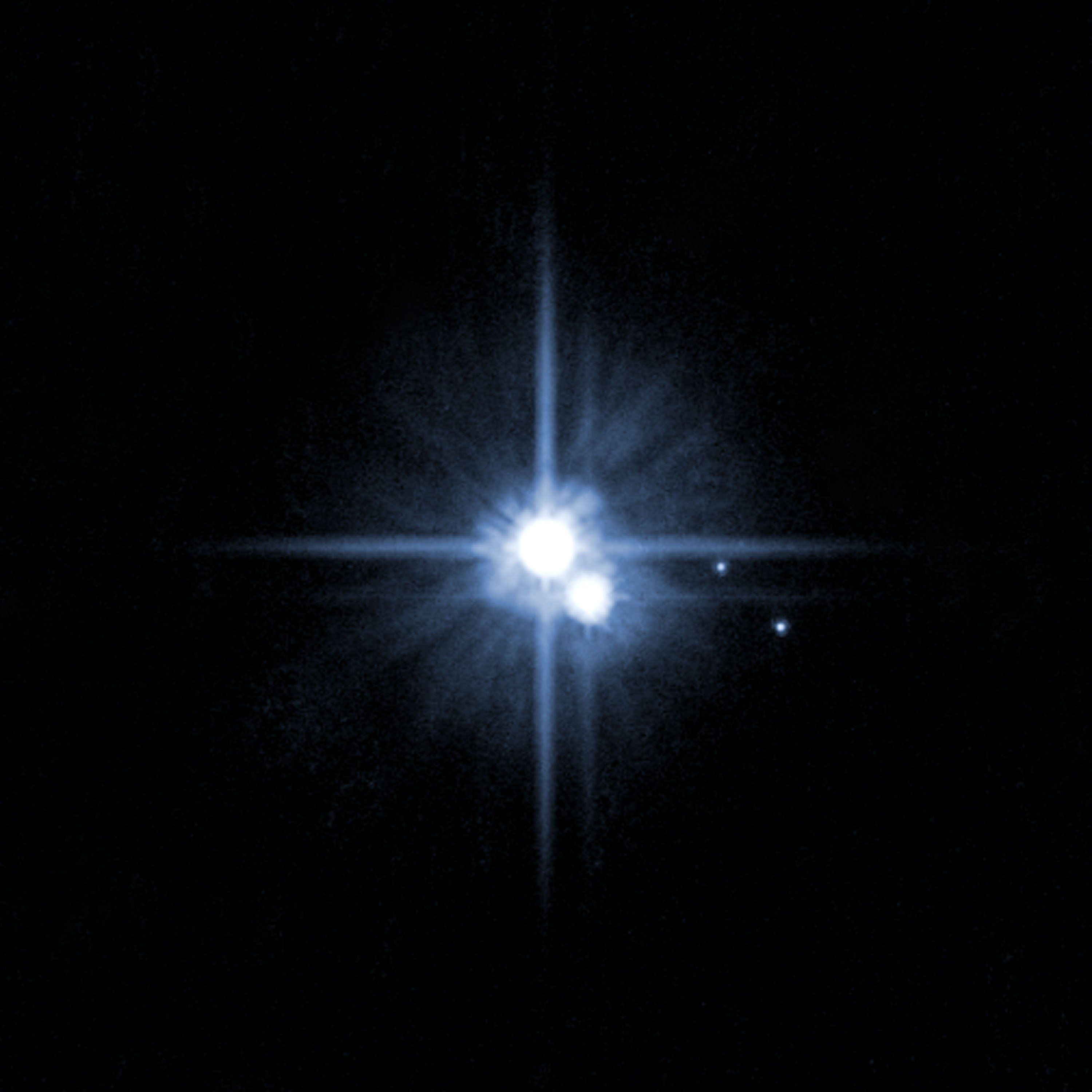 Pluto and its moons: Charon, Nix and Hydra. The surface composition of Pluto is frozen water, nitrogen, methane, carbon monoxide. Charon is composed on water and ice.