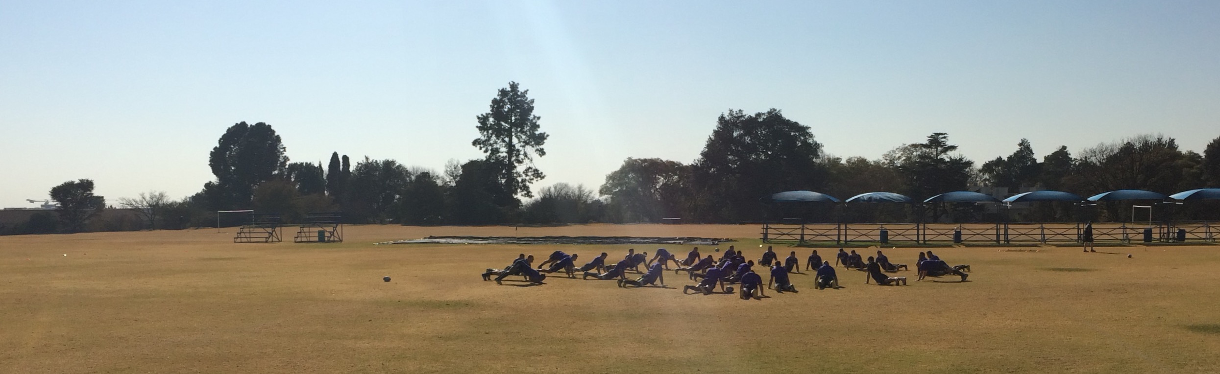 The All Blacks stretching under the hot sun. 