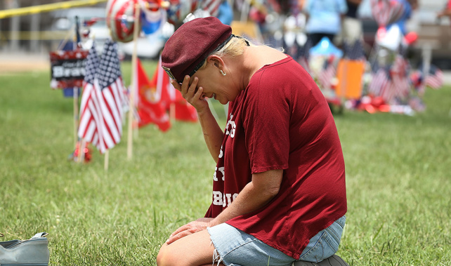 Mourners at one site where the shooting took place (Getty Images) 