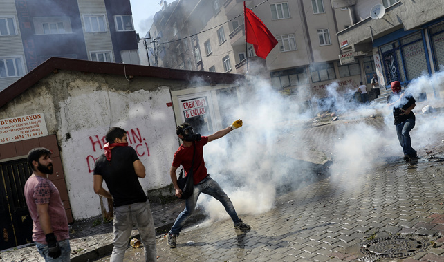 Left-wing militants are tear gassed during clashes with Turkish police officers in Istanbul (Getty Images) 