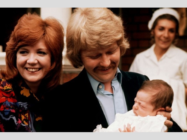 The singer and husband Bobby pose for photos with their 10-day old baby Robert as they leave the clinic at St Johns Wood in London.