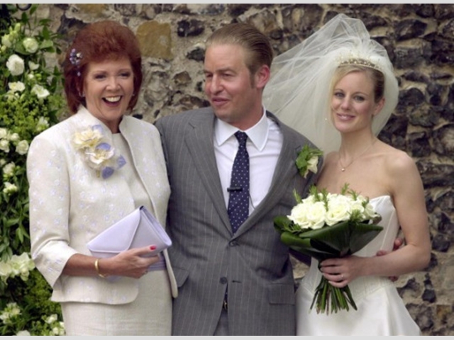 With her son Robert and his wife Fiona after their wedding at St Mary The Virgin Church in Denham, Buckinghamshire in 2001.