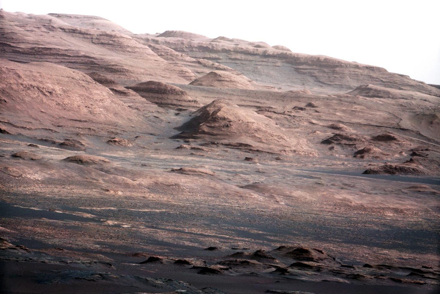 The base of Mount Sharp as seen by Curiosity before it arrived at the mountain, which is a little larger than Mount Rainier on Earth. Curiosity is now exploring the low elevations of Mount Sharp.