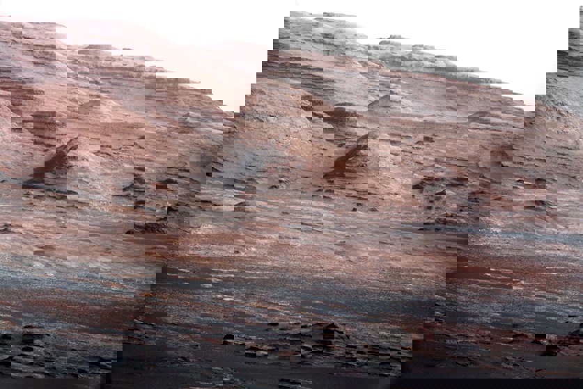 The base of Mount Sharp as seen by Curiosity before it arrived at the mountain, which is a little larger than Mount Rainier on Earth. Curiosity is now exploring the low elevations of Mount Sharp.