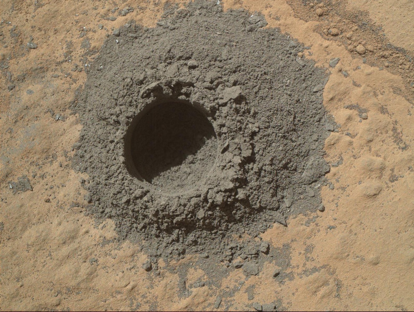 A drill hole left by the Curiosity rover, while collecting soil samples in April of 2014.