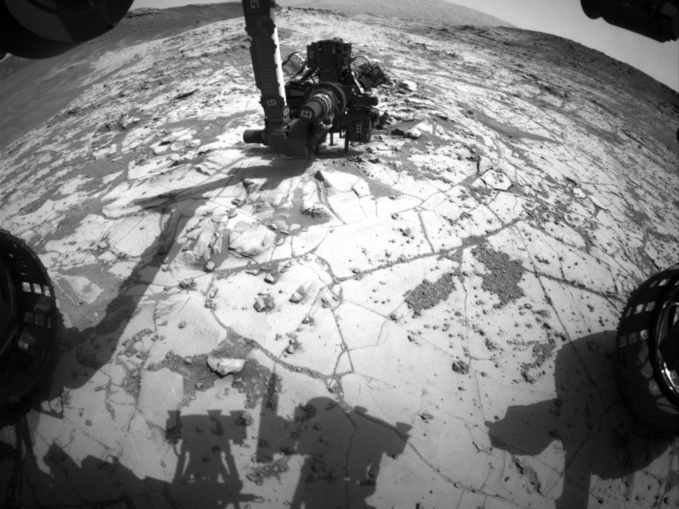 An image of the Curiosity rover's drill in position for a mini-drill test.