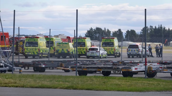 There is a large emergency services turnout waiting for the flight to land. Photo / George Heard