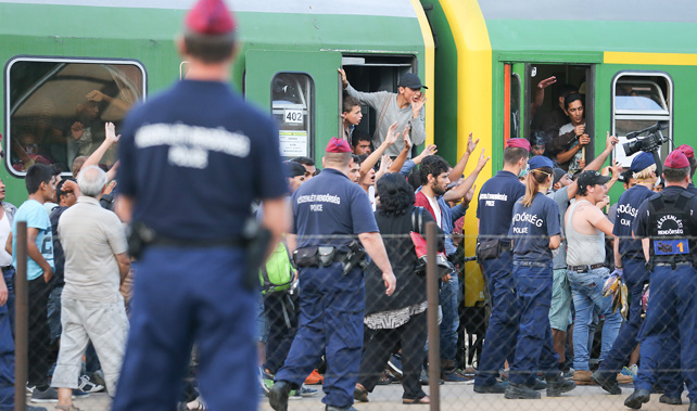 Migrants refuse to be taken to a refugee camp from a train near Budapest (Getty Images) 