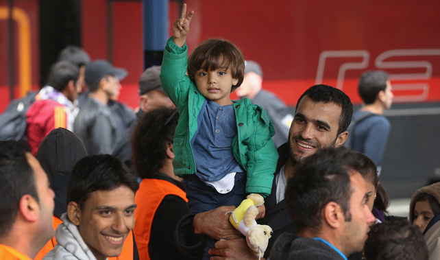 A child who arrived with migrants on a train from Hungary gestures at a Munich railway station (Getty Images)