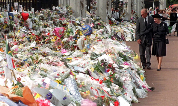 The Duke of Edinburgh (L) and Queen Elizabeth view the thousands of flowers and tributes left outside Kensington Palace in memory of Diana, Princess of Wales, 05 September 1997